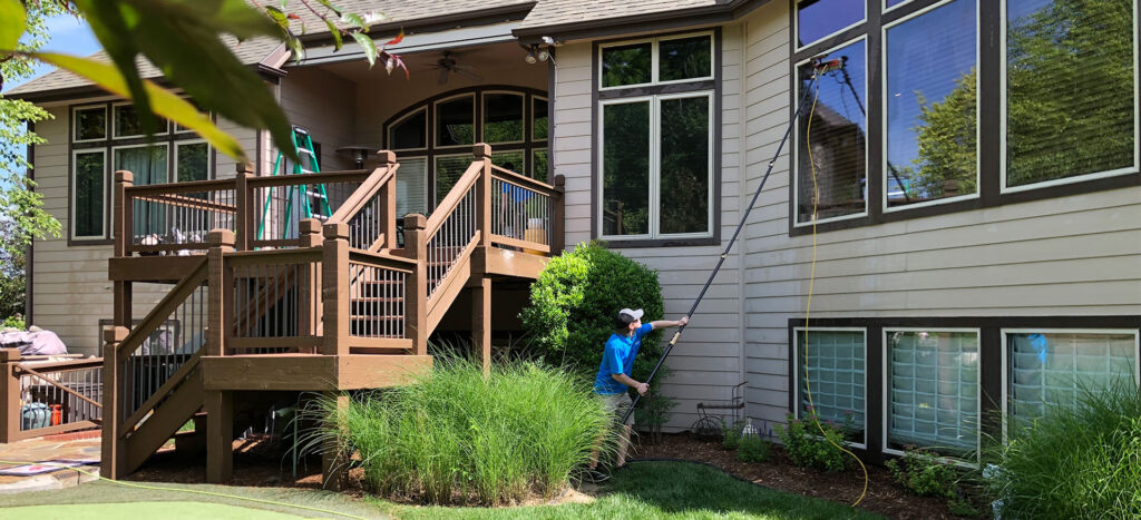 A man cleaning a home window